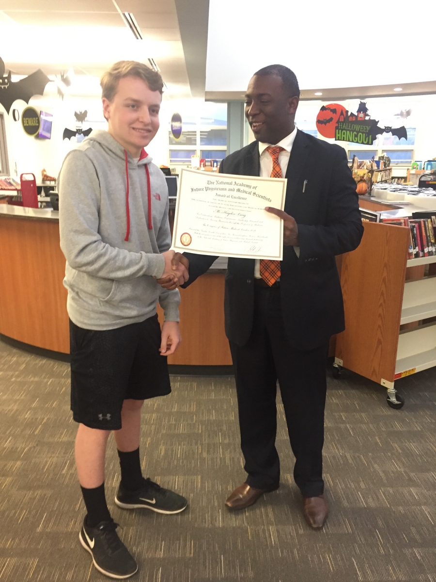 Hayden Lang receiving Award for Congress of Future Medical Leaders from Principal Baggett